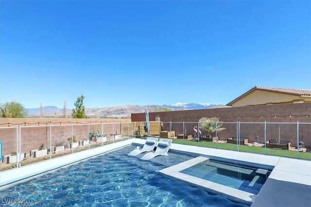view of swimming pool with a mountain view and a fenced backyard