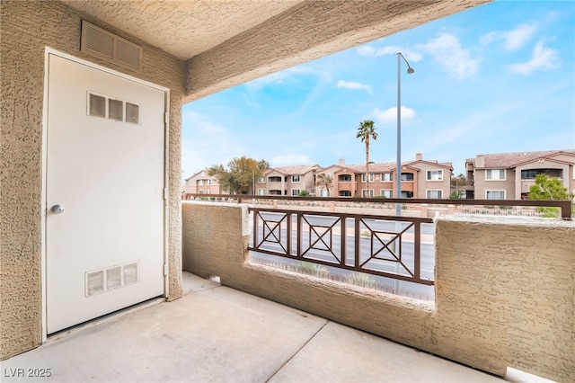 balcony with a residential view and visible vents