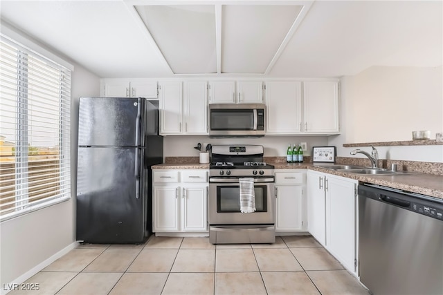 kitchen featuring light tile patterned floors, white cabinetry, stainless steel appliances, and a sink