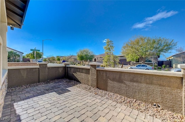 view of patio / terrace with fence and a residential view