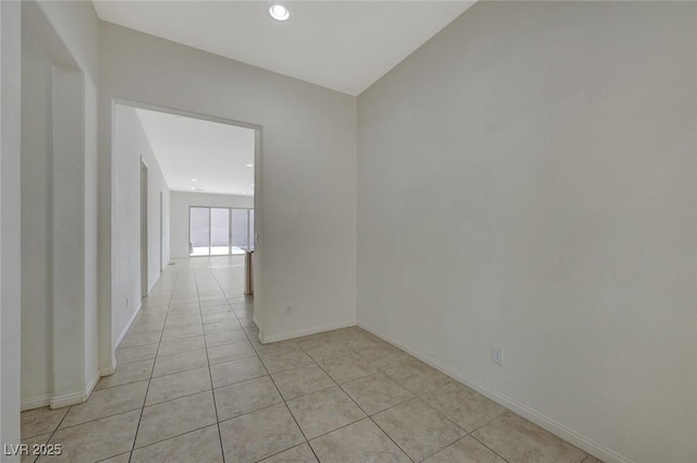 unfurnished room with light tile patterned floors, baseboards, and recessed lighting