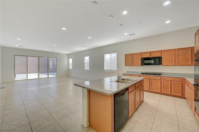 kitchen featuring black appliances, light tile patterned floors, recessed lighting, and a sink