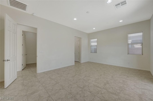 spare room featuring visible vents, recessed lighting, and baseboards