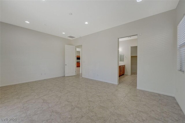 spare room featuring recessed lighting, baseboards, and visible vents