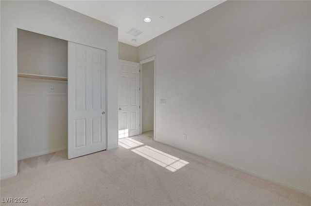 unfurnished bedroom featuring baseboards, visible vents, carpet floors, recessed lighting, and a closet