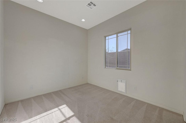 carpeted spare room featuring recessed lighting, visible vents, and baseboards