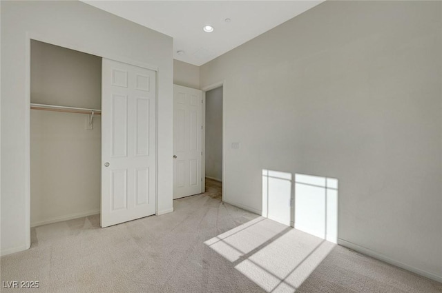 unfurnished bedroom with recessed lighting, carpet, baseboards, and a closet