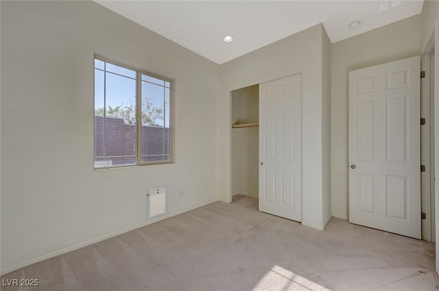 unfurnished bedroom with light carpet, recessed lighting, baseboards, and a closet