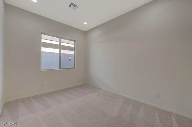 unfurnished room with recessed lighting, visible vents, light carpet, and baseboards