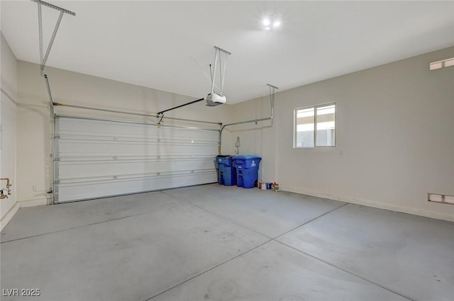 garage featuring a garage door opener and baseboards