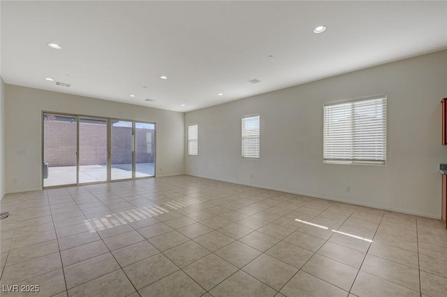 empty room with light tile patterned floors, visible vents, baseboards, and recessed lighting