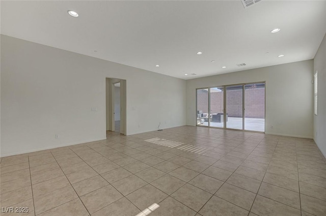 empty room featuring light tile patterned floors, recessed lighting, and baseboards