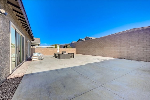 view of patio featuring an outdoor living space and a fenced backyard