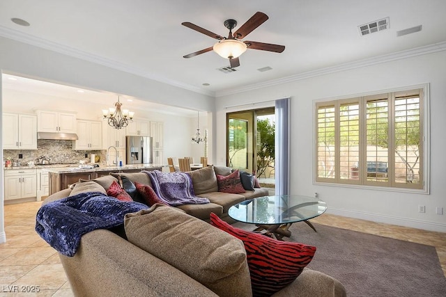 living area featuring crown molding, light tile patterned flooring, and visible vents