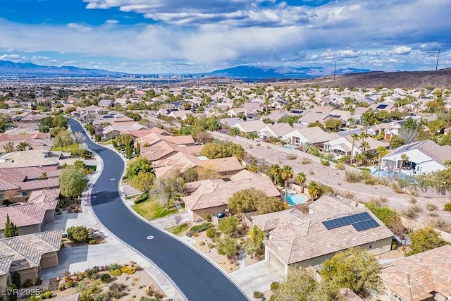 birds eye view of property with a mountain view and a residential view