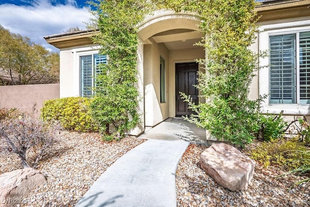 property entrance featuring stucco siding