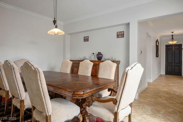 dining area featuring crown molding, light tile patterned floors, and baseboards