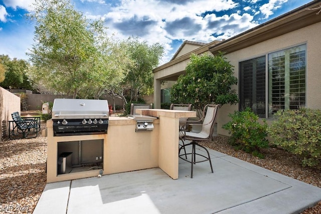 view of patio / terrace featuring area for grilling and fence