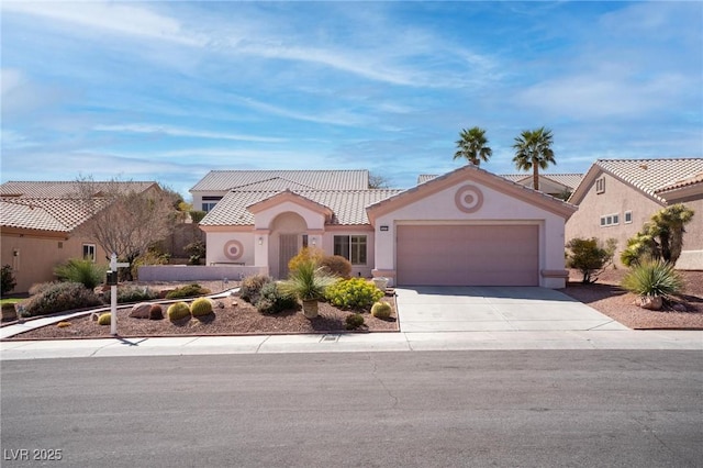 mediterranean / spanish house featuring stucco siding, a tiled roof, concrete driveway, and a garage