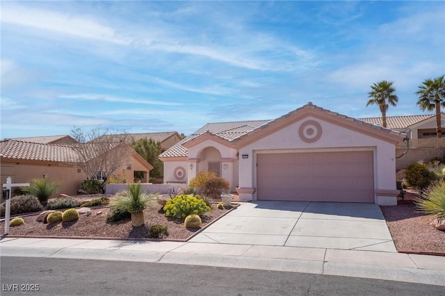 mediterranean / spanish-style house with stucco siding, an attached garage, driveway, and a tile roof