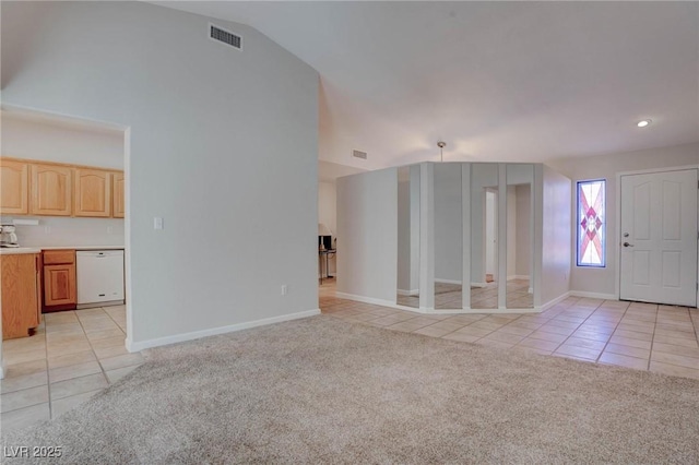 unfurnished living room featuring visible vents, baseboards, light colored carpet, and light tile patterned flooring