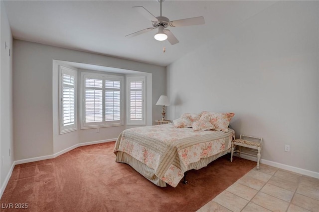 tiled bedroom with ceiling fan and baseboards