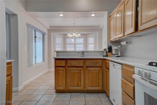 kitchen featuring an inviting chandelier, white appliances, light tile patterned floors, and light countertops