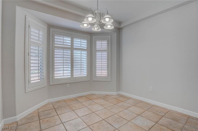 spare room featuring an inviting chandelier, light tile patterned floors, and baseboards