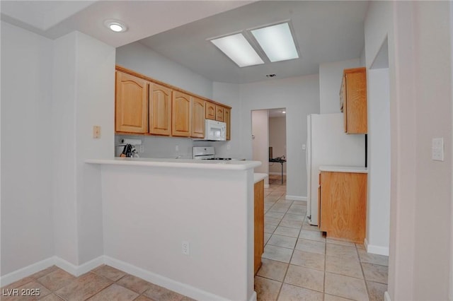 kitchen featuring white appliances, light countertops, visible vents, and baseboards