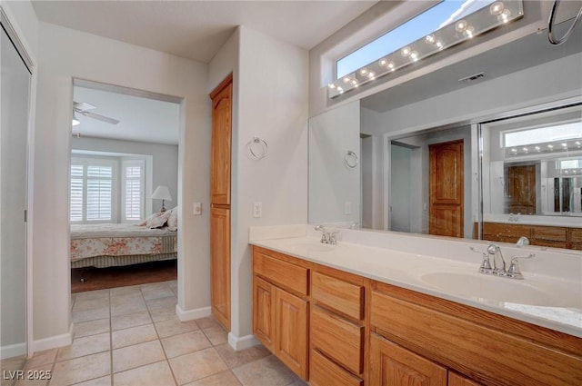 ensuite bathroom featuring a sink, visible vents, ensuite bath, and tile patterned flooring