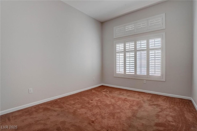 carpeted spare room with baseboards