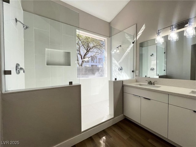 full bathroom with walk in shower, wood finished floors, and vanity