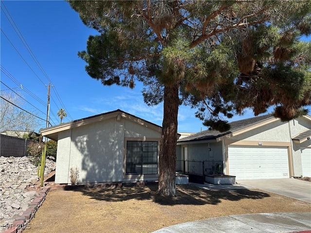 view of front of house with a garage, driveway, and stucco siding