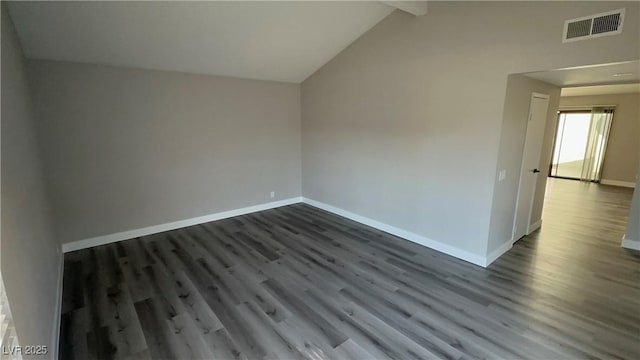 unfurnished room featuring lofted ceiling with beams, dark wood-style floors, baseboards, and visible vents