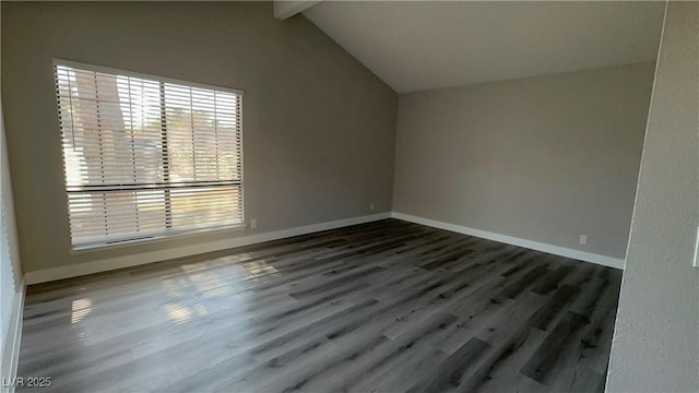 interior space featuring vaulted ceiling with beams, wood finished floors, and baseboards