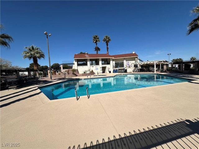 pool featuring a pergola, a patio area, and fence