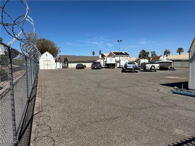 uncovered parking lot featuring fence