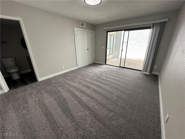 unfurnished bedroom with visible vents, baseboards, carpet floors, a textured ceiling, and access to outside