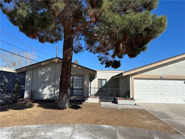 single story home with stucco siding, driveway, and an attached garage