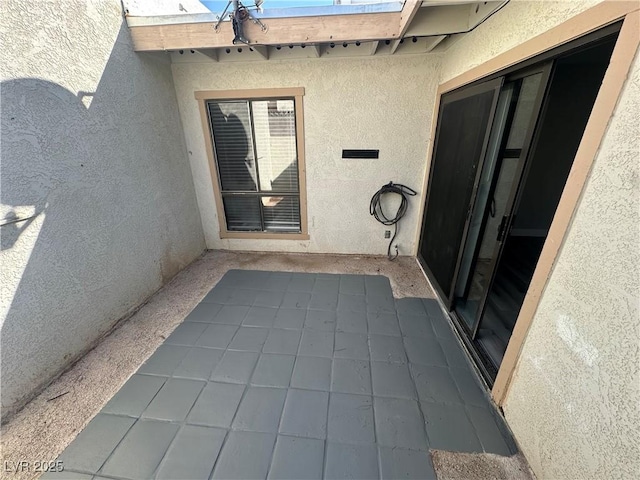 entrance to property with stucco siding