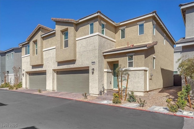 view of front of house featuring a garage and stucco siding