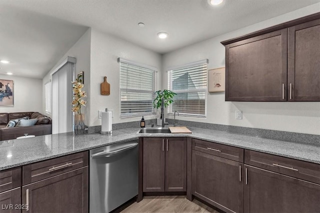 kitchen featuring dark brown cabinetry, dishwasher, a wealth of natural light, and a sink