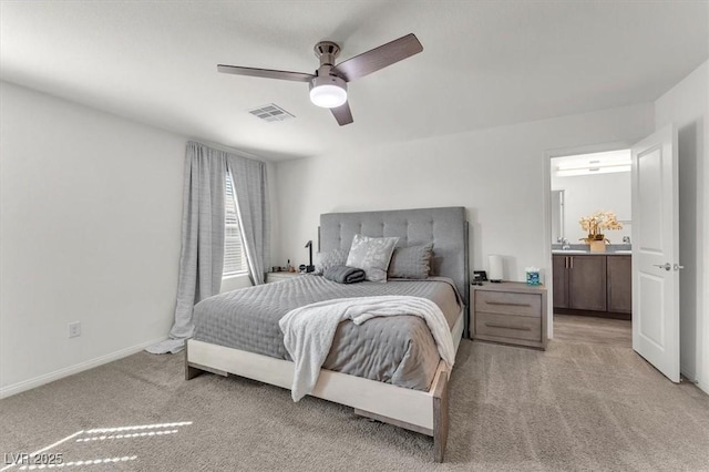 bedroom with visible vents, baseboards, light colored carpet, and a ceiling fan