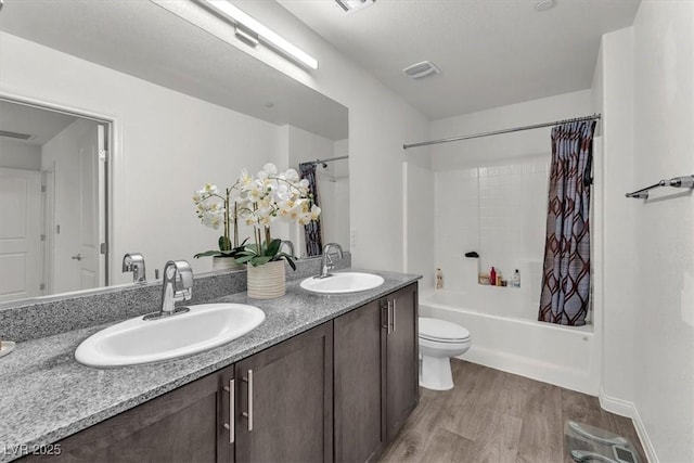 bathroom with a sink, wood finished floors, double vanity, and shower / bath combination with curtain