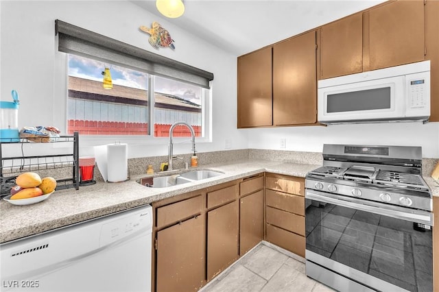 4153 Broadriver Dr, Las Vegas, NV 89108 - kitchen with light countertops, white appliances, a sink, and light tile patterned floors