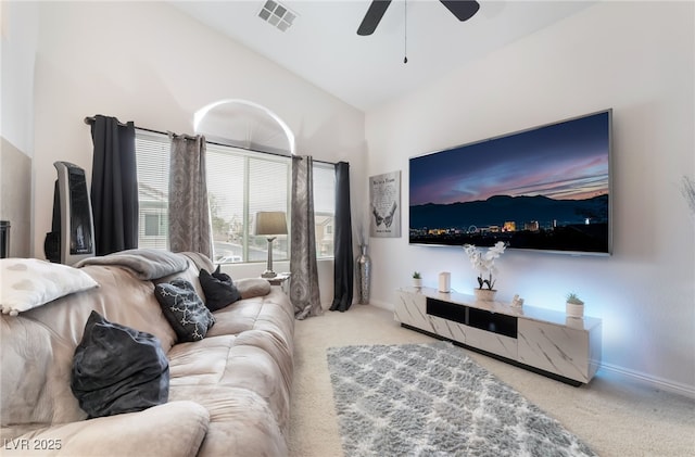 carpeted living room featuring high vaulted ceiling, baseboards, visible vents, and ceiling fan