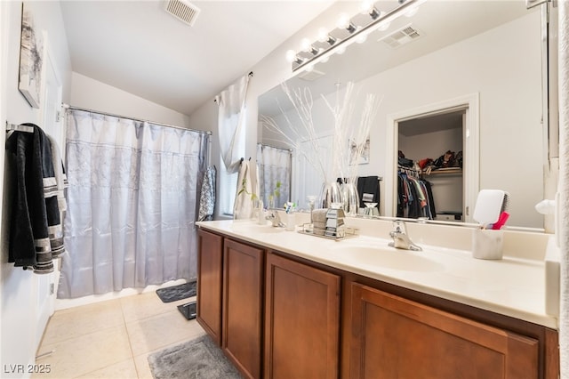 full bathroom with tile patterned flooring, double vanity, visible vents, and a sink