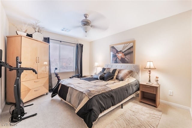 bedroom featuring visible vents, light colored carpet, baseboards, and ceiling fan