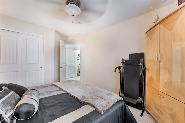 bedroom with a closet, light colored carpet, and ceiling fan