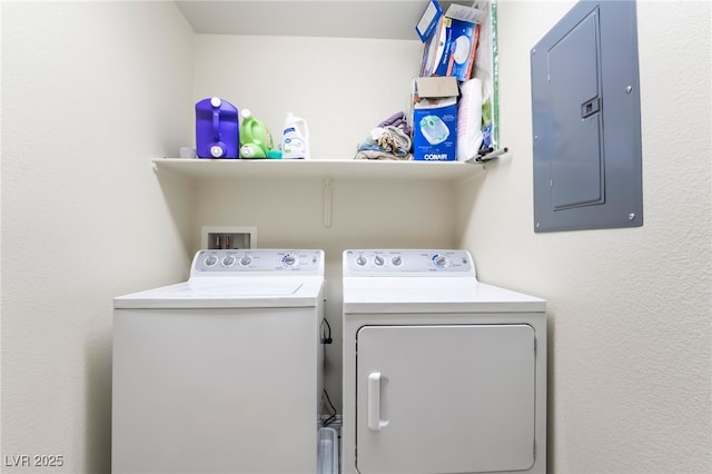 washroom featuring electric panel, laundry area, and separate washer and dryer